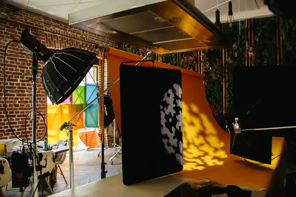 Photographer organizing studio equipment near a staging area