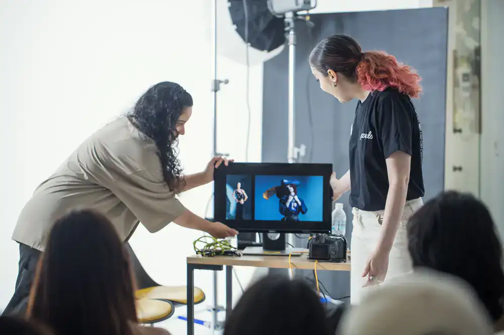 Creative team reviewing images on a tethered monitor
