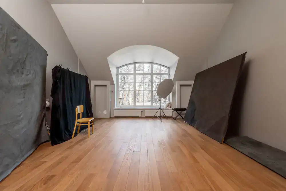 Bright spacious photography studio with natural light and a seamless backdrop