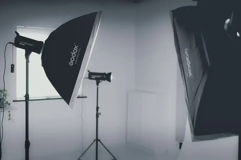 Professional strobe lighting setup on C-stands in the studio