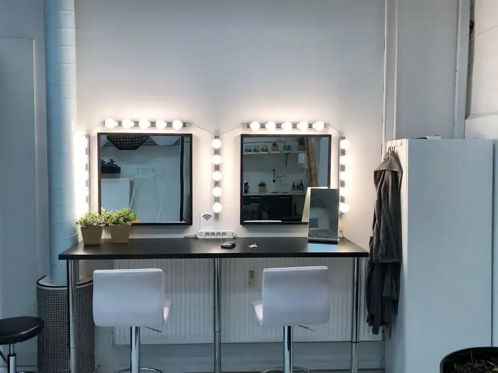 Dedicated makeup and styling area with daylight bulbs
